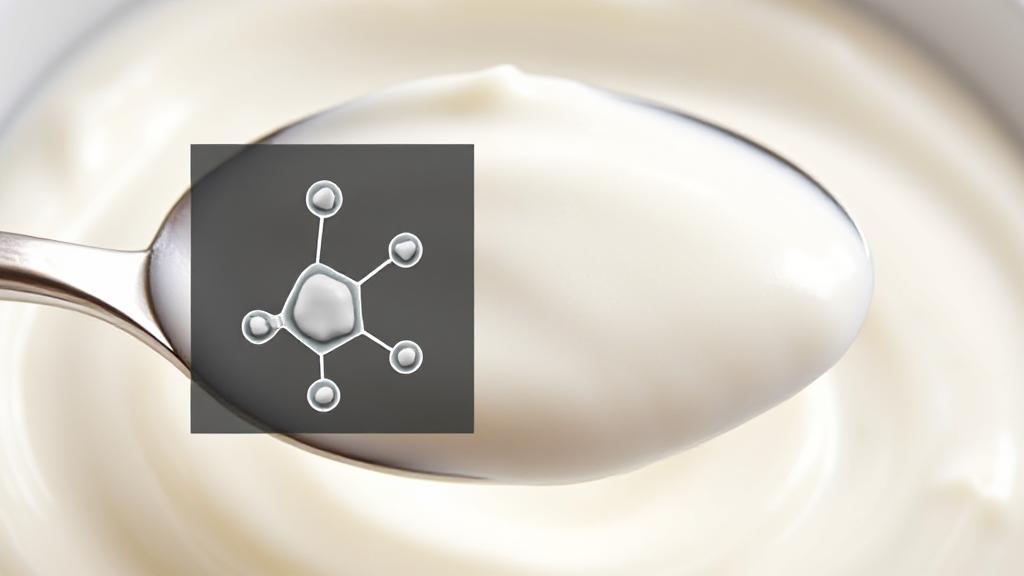 A close-up shot of a spoonful of creamy yogurt with a small lactose molecule illustration overlay.