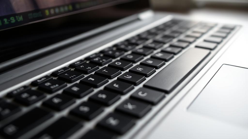 A close-up shot of a well-used laptop keyboard with a subtle overlay of a clock face, symbolizing the passage of time and device longevity.